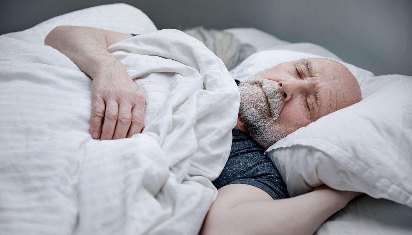 Man sleeping in bed.